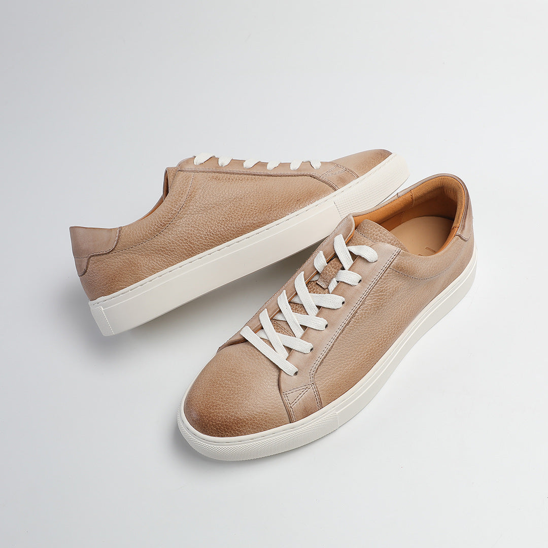 Carter Court Sneakers in Beige — angled pair on a white cupsole
