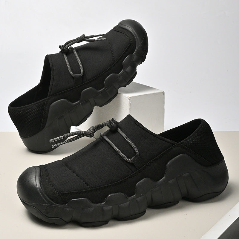 Amos Canvas Sneakers in Black — premium cushioned slip-on with bungee toggle and lugged sole