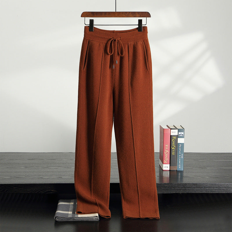 Margot Cashmere Trousers in Dark Orange — high-rise knit trousers on a hanger