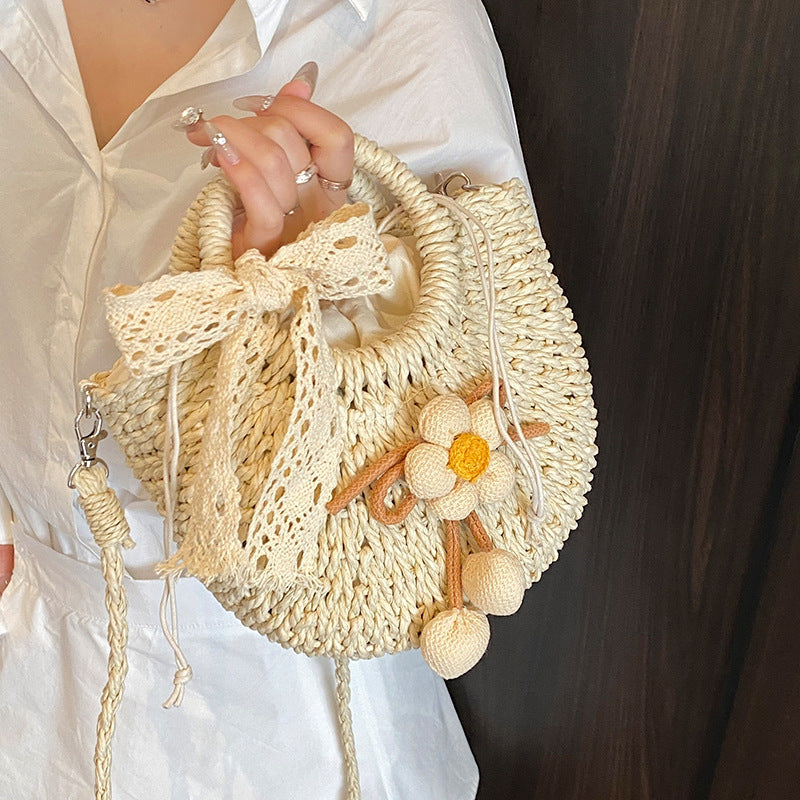 Noemi Straw Bag in Beige on model — woven straw handbag with lace bow