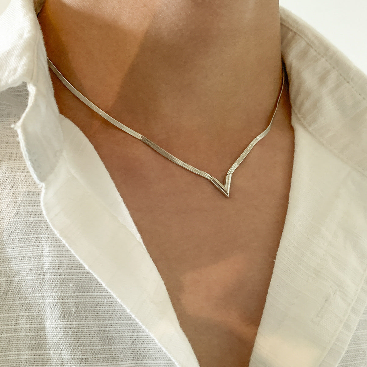 Felix Necklace in Silver — polished snake-chain V-drop necklace