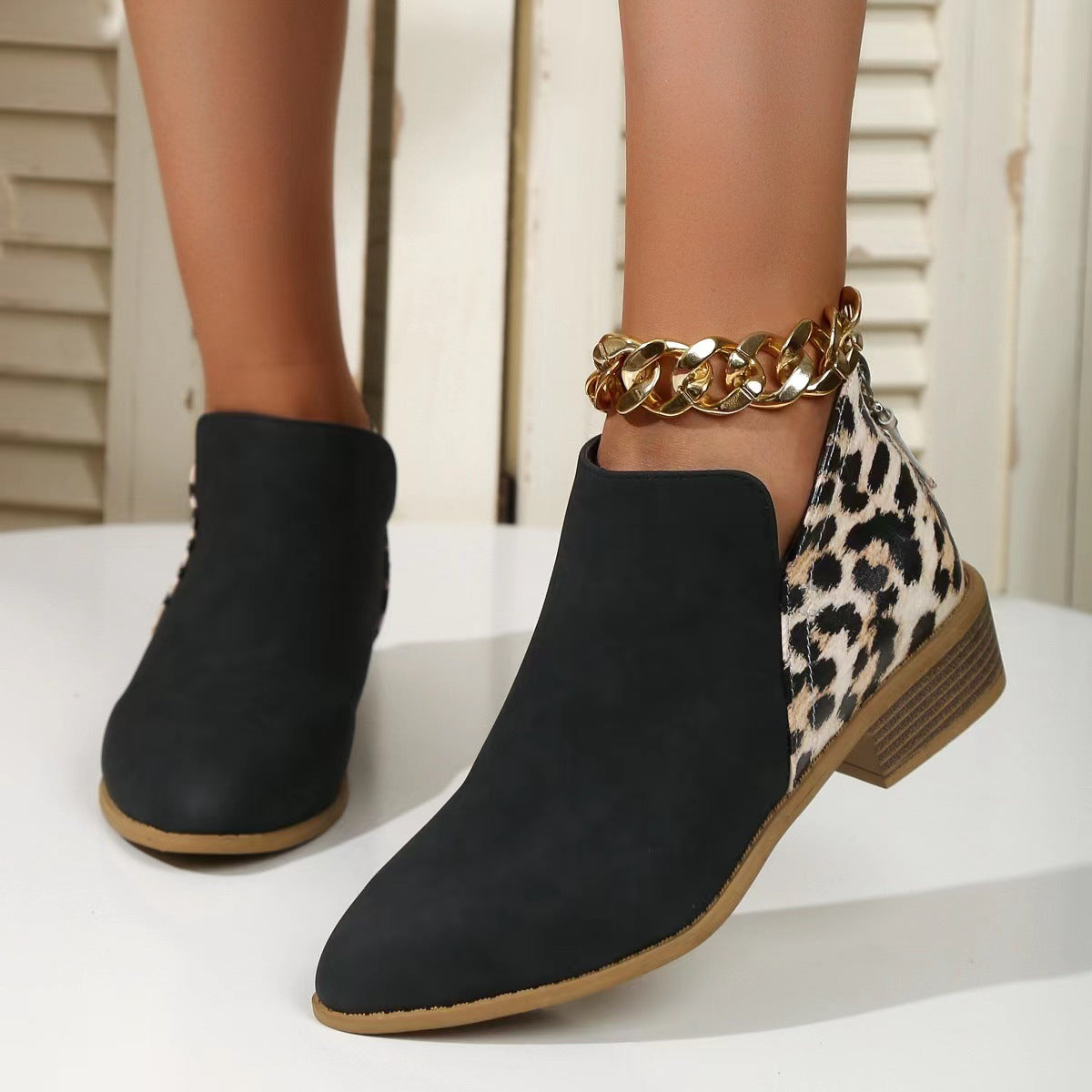 Esme Leopard Boots in Black — worn pair styled with an ankle chain