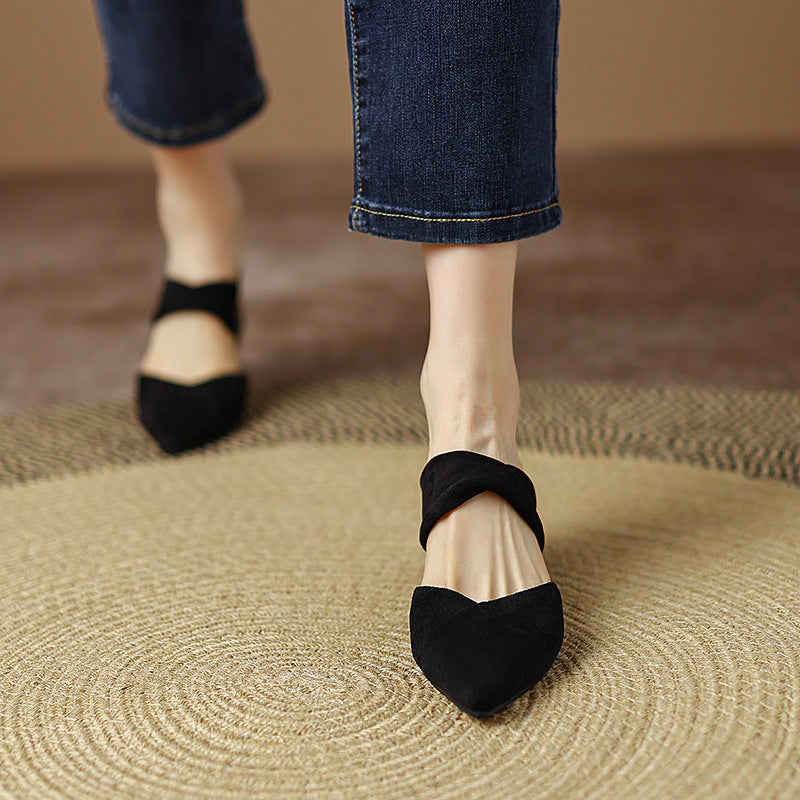 Thea Knotted Mules in Black — worn walking