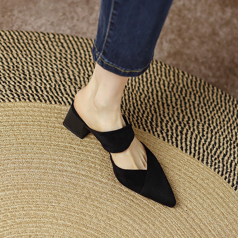 Thea Knotted Mules in Black — worn with denim