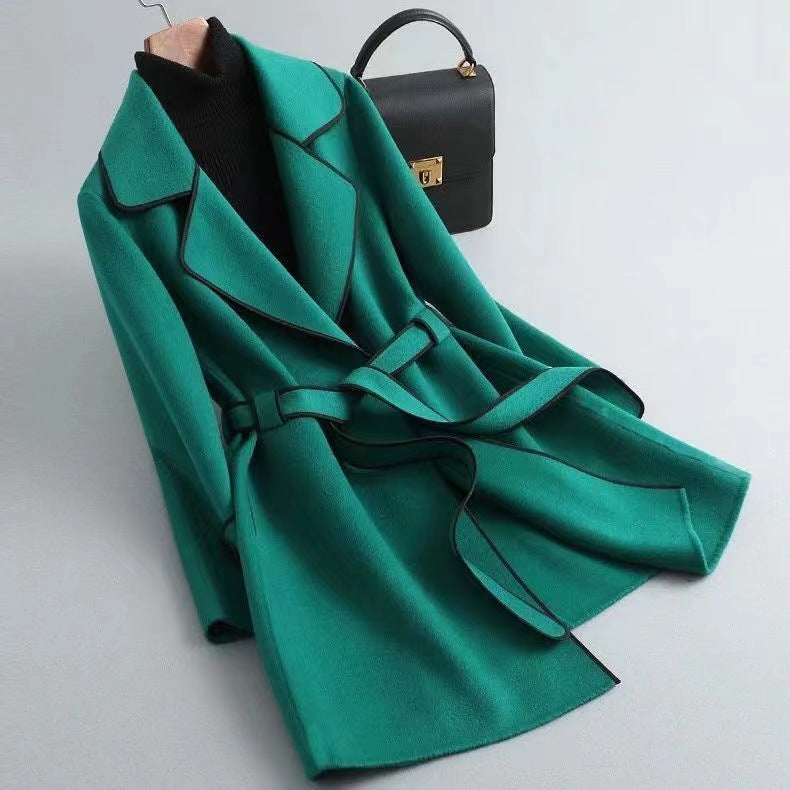 Delphine Wool Coat in Green — women's belted wool coat with contrast piping, tie belt, and notched lapel