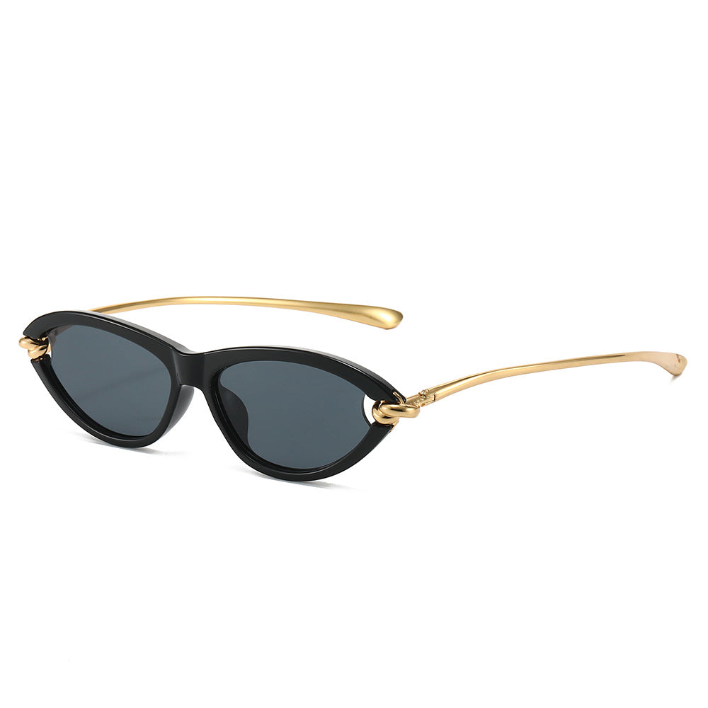Paloma Sunglasses in Black — glossy cat-eye sunglasses with gold-knot temples