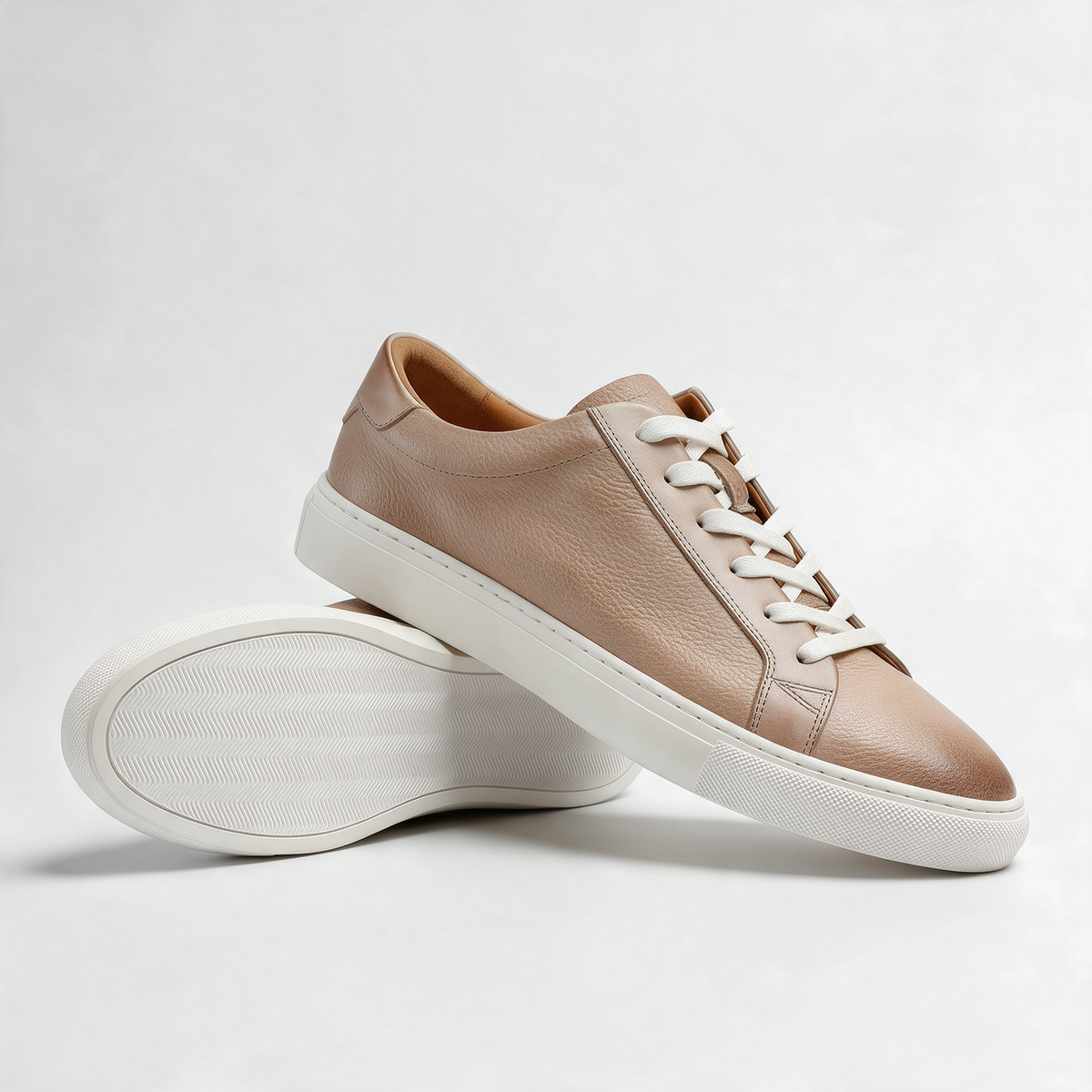 Carter Court Sneakers in Beige — angled pair with the white cupsole showing