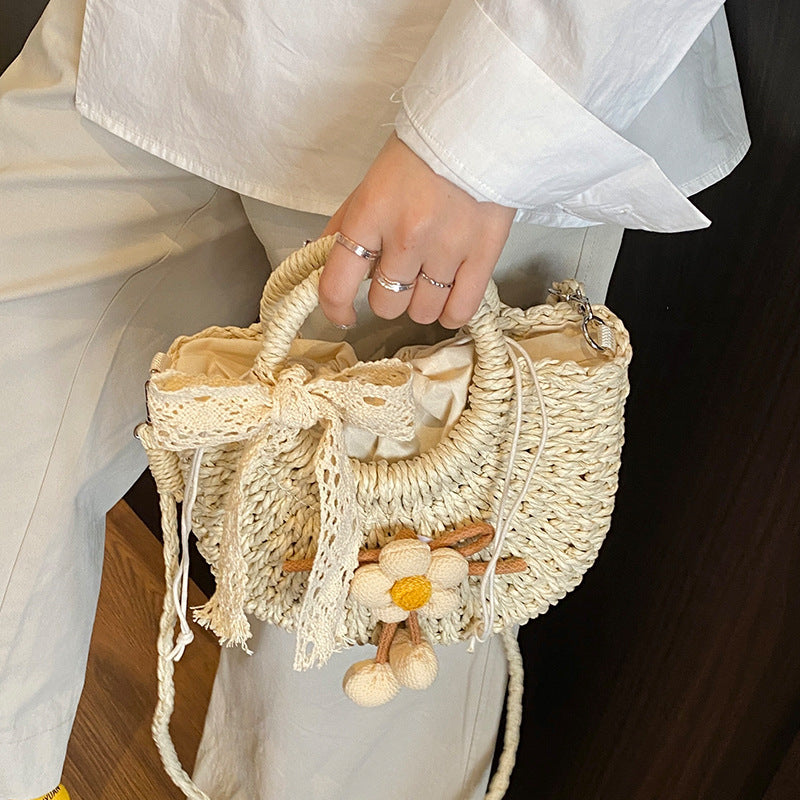 Noemi Straw Bag in Beige on model — woven straw handbag with lace bow