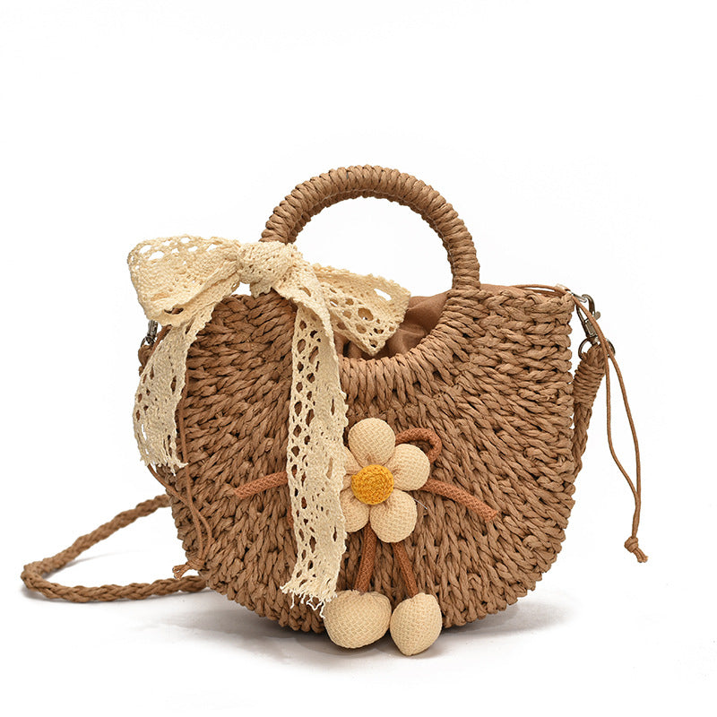 Noemi Straw Bag in Brown — woven straw handbag with lace bow