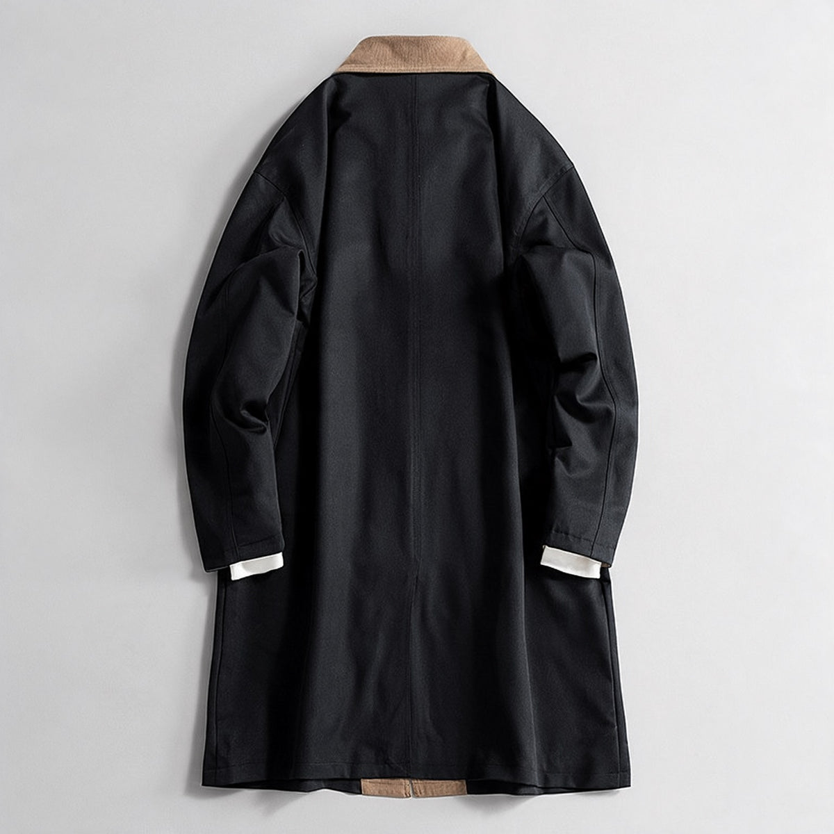 Sutton Trench Coat in Black — back view showing the centre walking vent and relaxed drop shoulder
