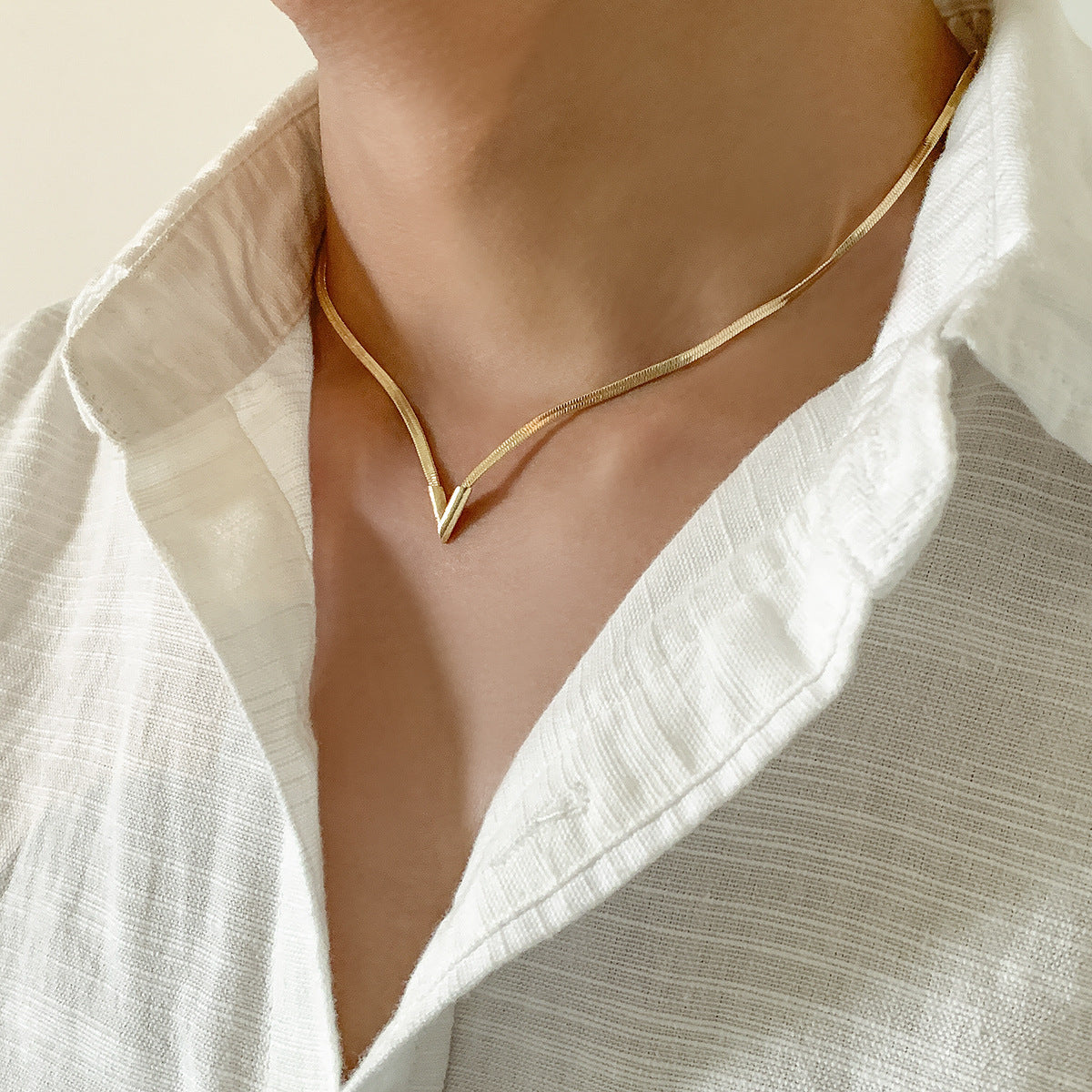 Felix Necklace — polished snake-chain V-drop necklace detail view
