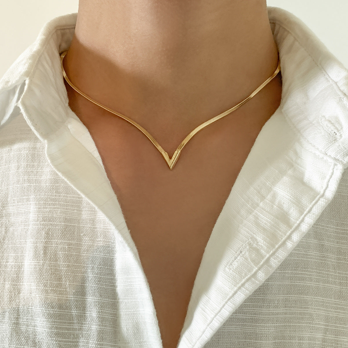 Felix Necklace in Gold — polished snake-chain V-drop necklace