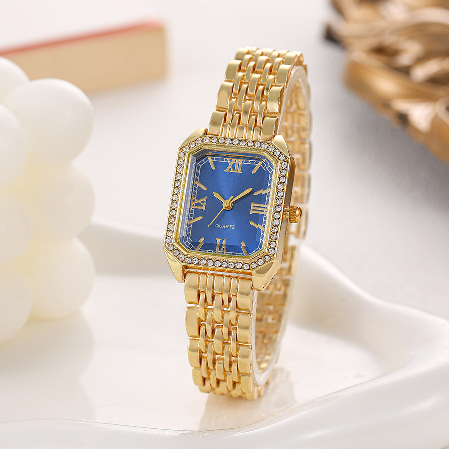 Seraphine Crystal Watch in Blue — gold-tone bracelet watch with crystal-lined bezel and Roman numerals