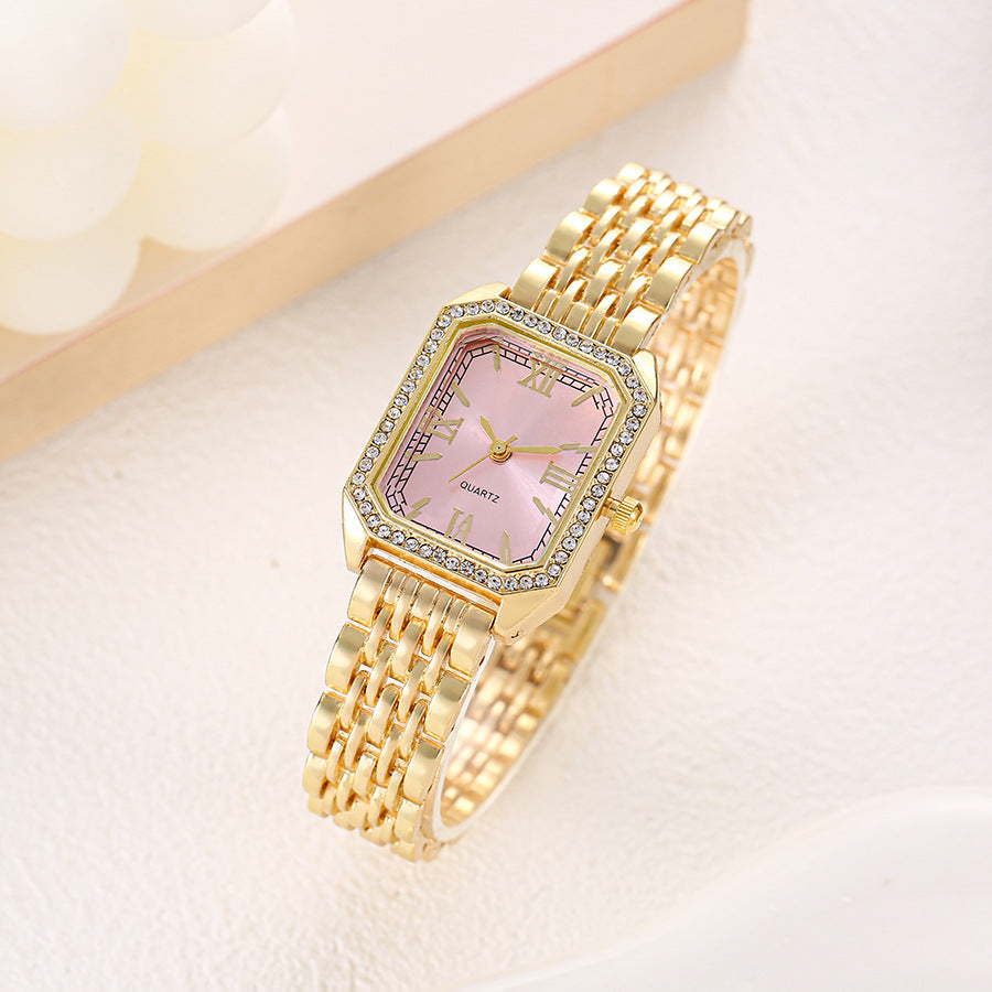 Seraphine Crystal Watch in Pink — gold-tone bracelet watch with crystal-lined bezel and Roman numerals